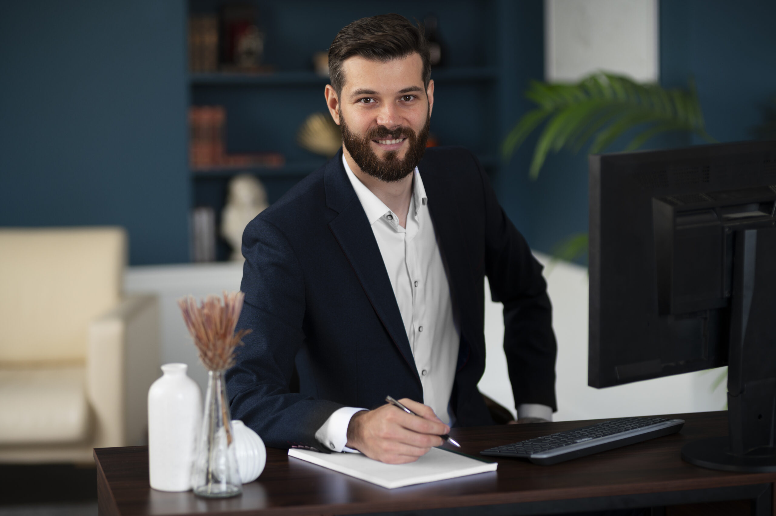 Why Sarbazo medium shot smiley man sitting desk scaled