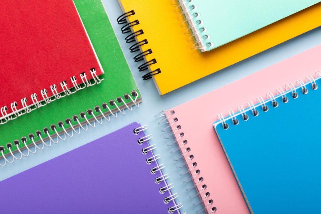 coloured notebooks arranged properly on a surface